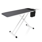 A long rectangular ironing board with memory foam padding and a storage pocket.