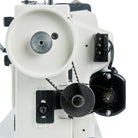 Close-up of a sewing machine mechanism on a white background